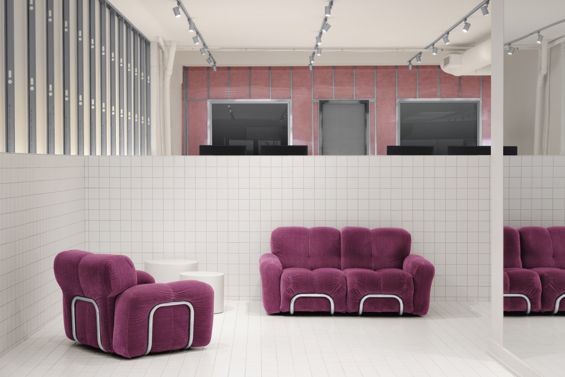 Purple sofas with raised work area behind
