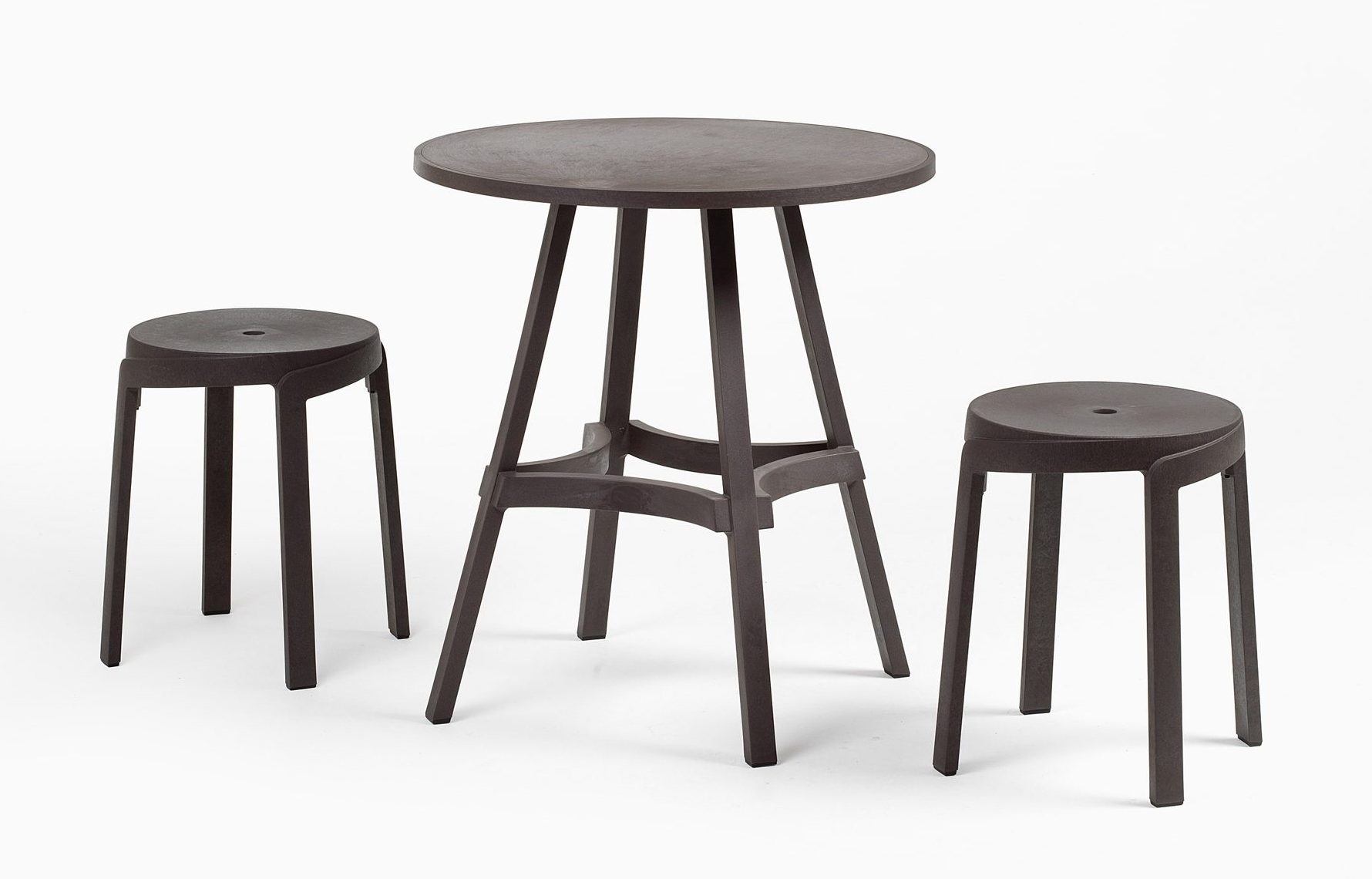 Photograph of short stools next to short table on white bacckdrop