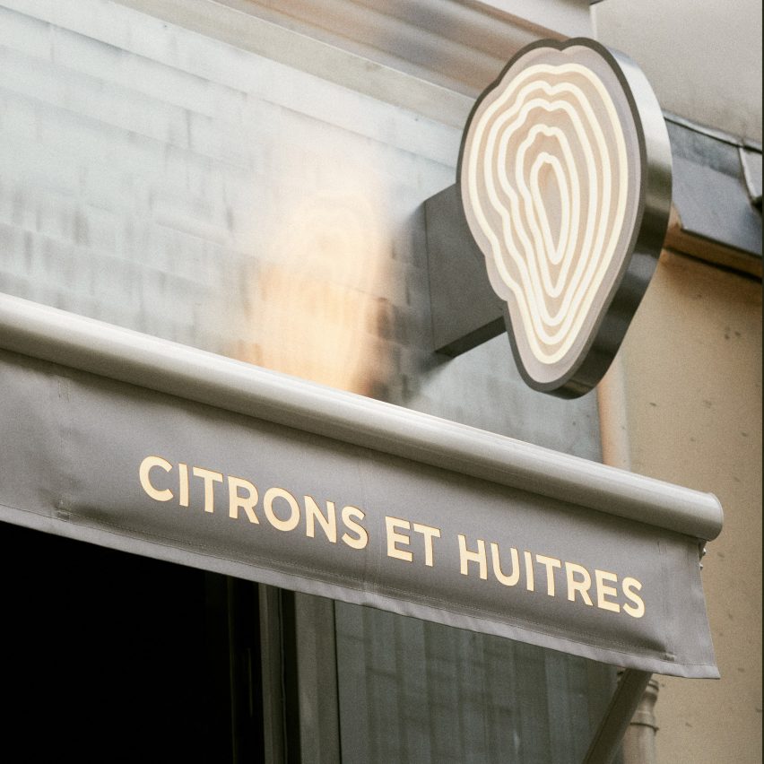 Outside a Parisian oyster bar, featuring a oyster-shaped neon sign