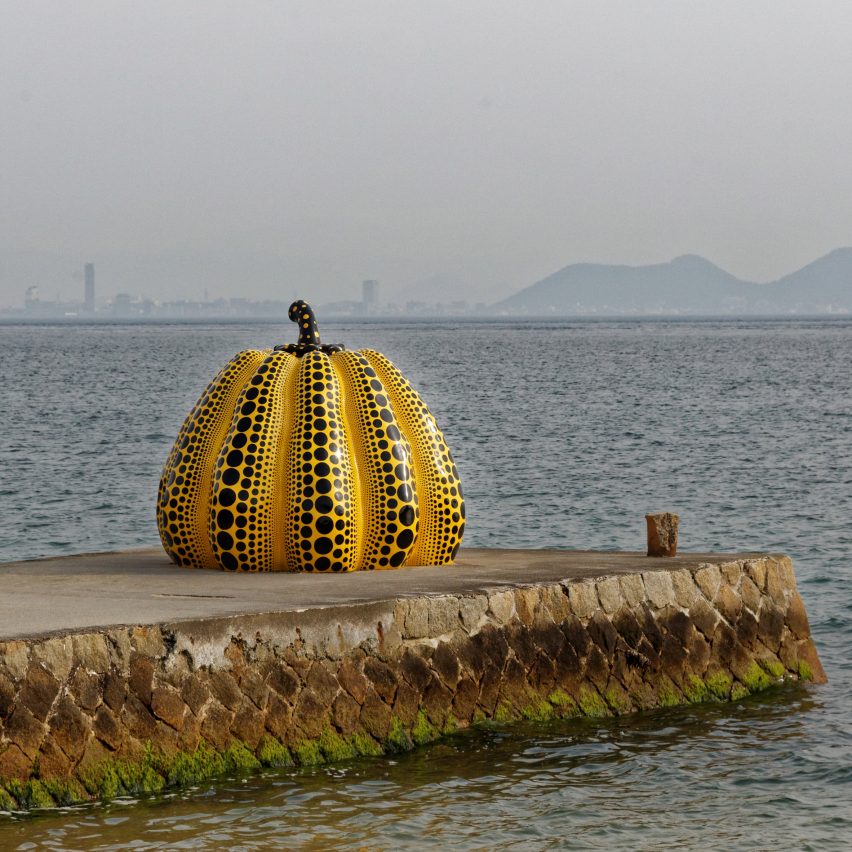 Pumpkin sculpture on pier by Yayoi Kusama