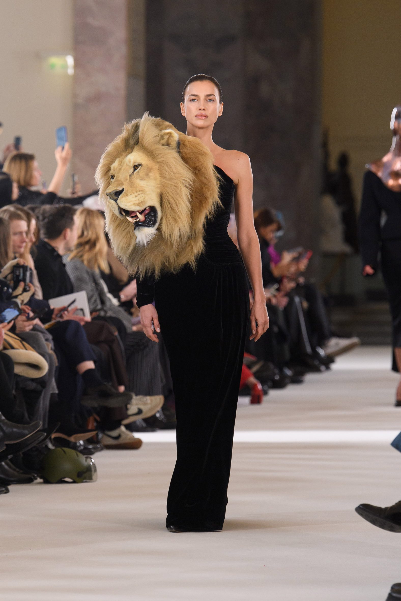Photo of Irina Shayk wearing a faux lion head at Schiaparelli