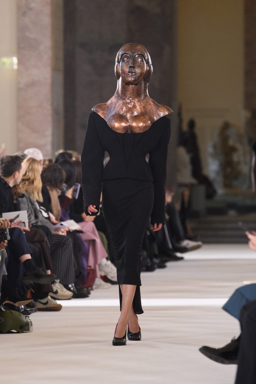 A copper bust is worn by a model at the Schiaparelli show