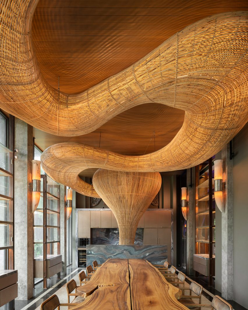 Winding rattan structure in a living room by Enter Projects Asia