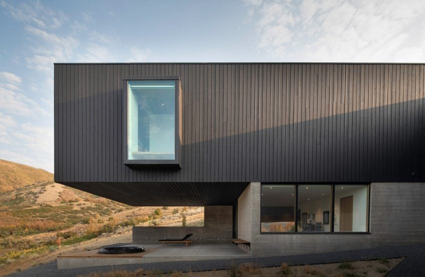 Blackened stained finish on facade of rectilinear house