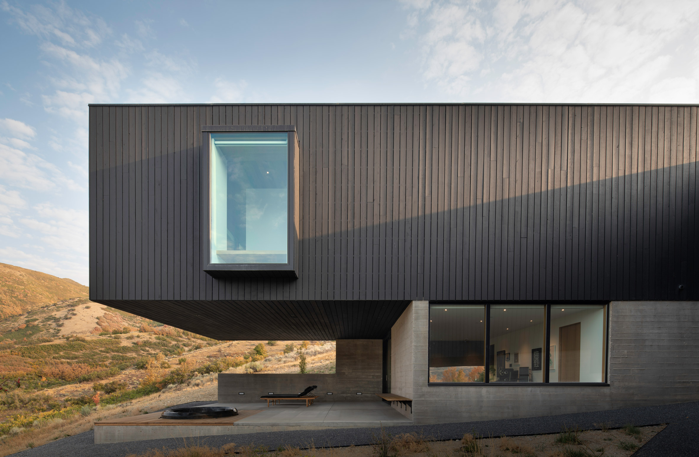 Blackened stained finish on facade of rectilinear house