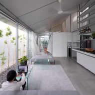 Open plan steel kitchen and living space with mono-pitched roof