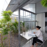 Office study space in a steel structure home overlooking an outdoor courtyard