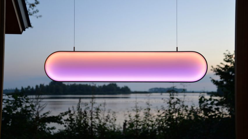 Glowing pink lamp hung in window