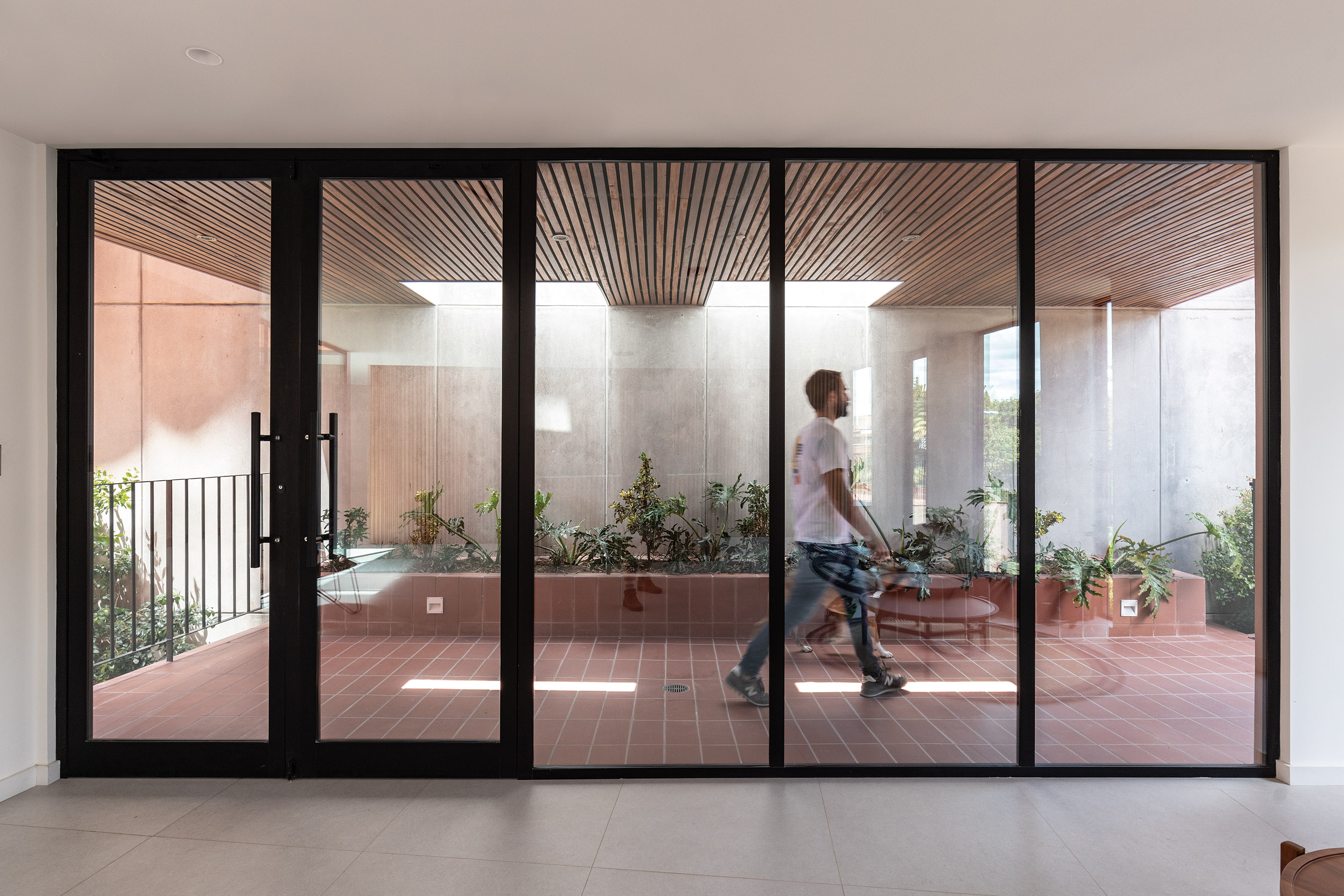 Rectilinear glass doors within building by Urlo Studio in Ecuador