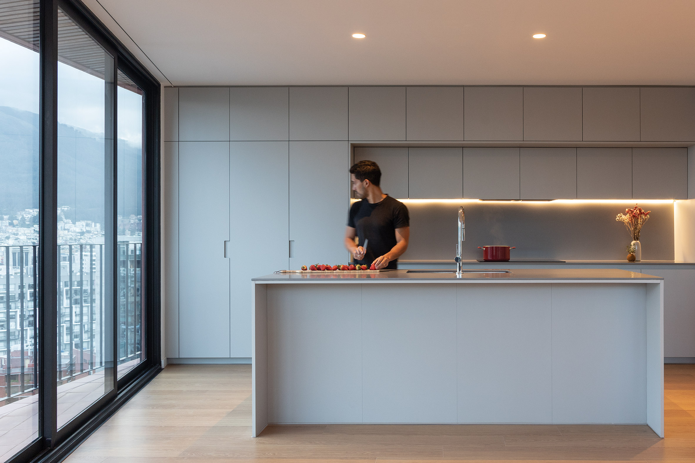 Minimalist kitchen within apartment in Olvia building by Urlo Studio