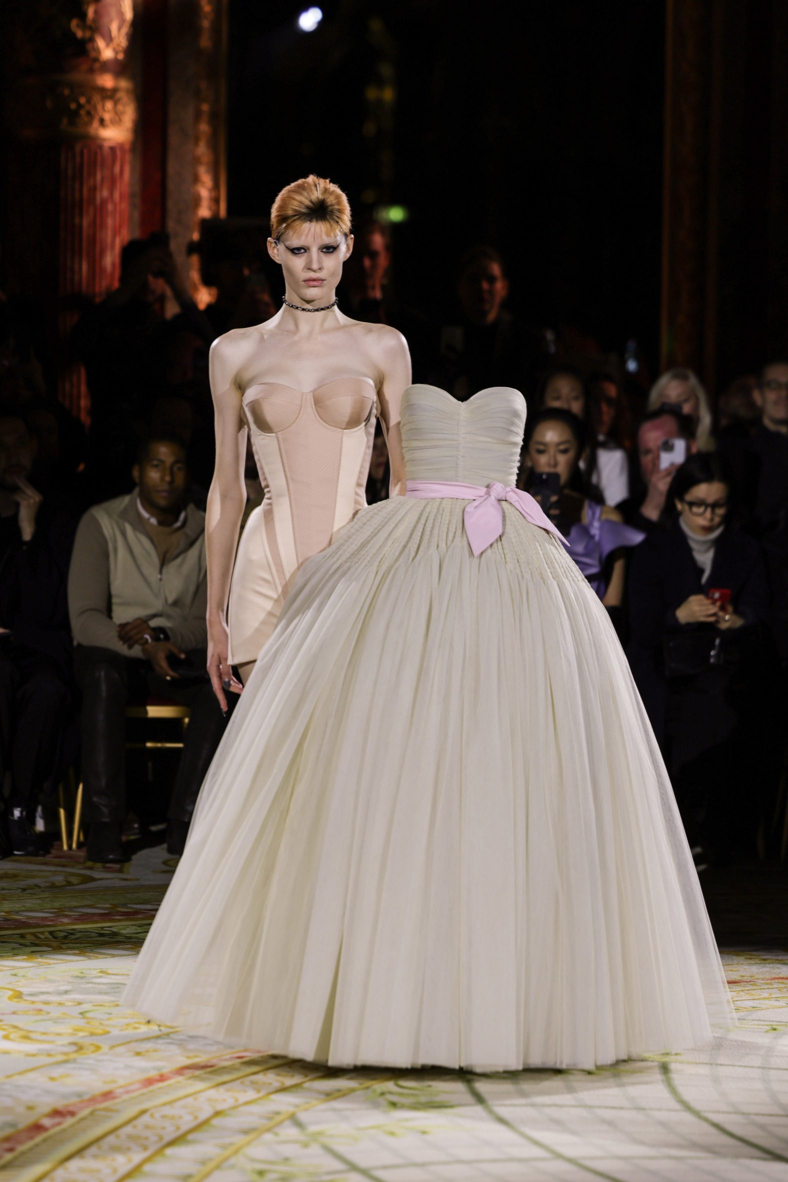 3D-printed dress positioned alongside its wearer on the catwalk