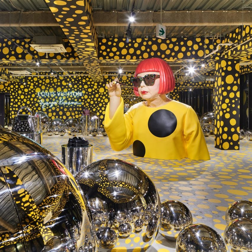 A large-scale sculpture of Yayoi Kusama mimics the act of painting in a decorated Louis Vuitton store