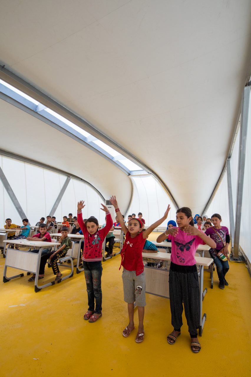 Children in ZHA-designed refugee tent