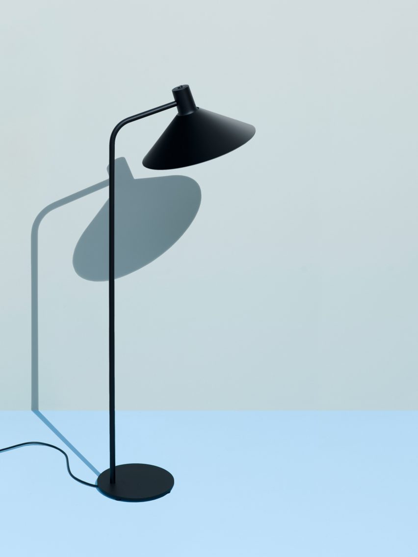 Black floor lamp on blue and grey backdrop