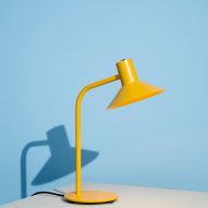 Yellow table lamp on blue and grey backdrop