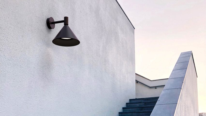 Black sconce lamp on exterior wall above outdoor staircase
