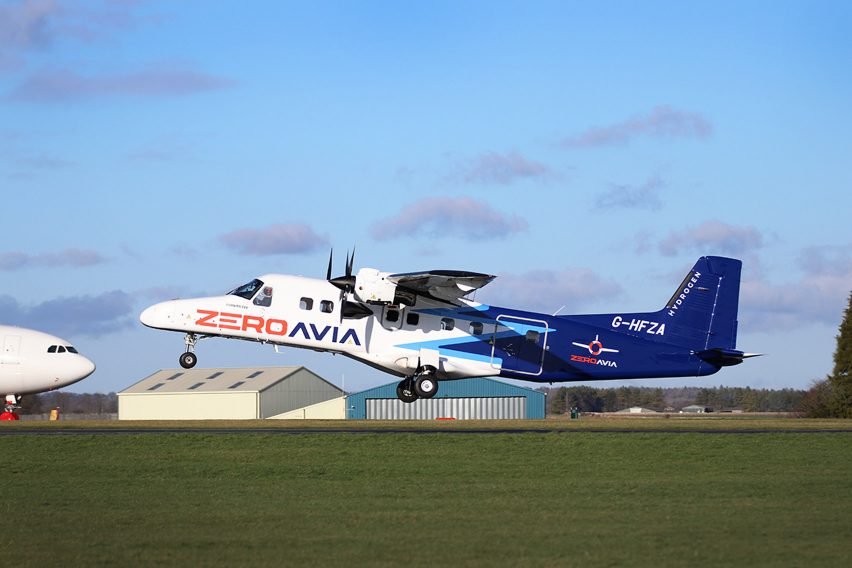 Photo of a white and blue painted turboprop plane with ZeroAvia branding on the side taking off from a runway