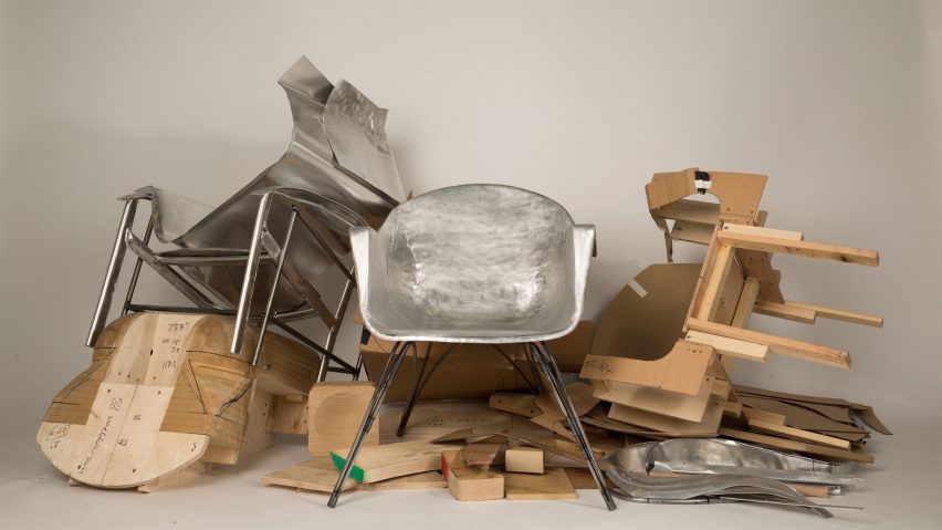 Silver armchair surrounded by a lot of metal material and wood scraps
