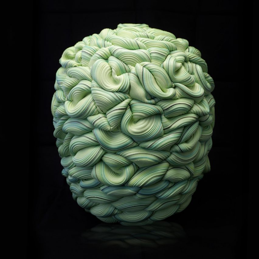 Green sculptural object on a black background