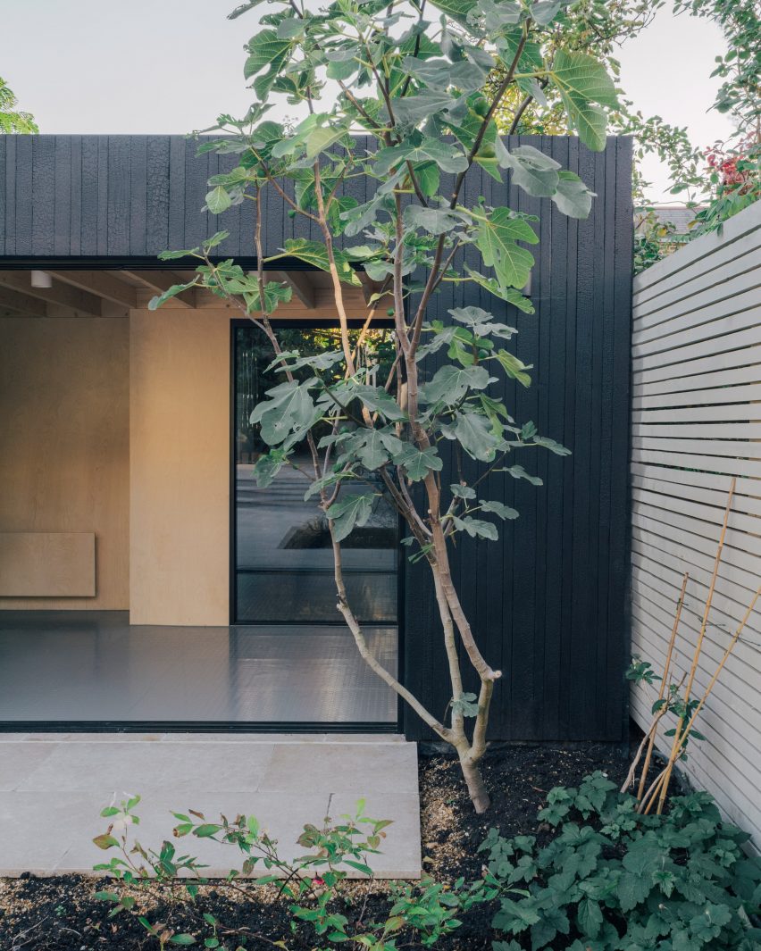 Photograph of a garden studio with a charred-wood clad facade