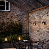 Aludra wall garden lights in an outdoor seating area