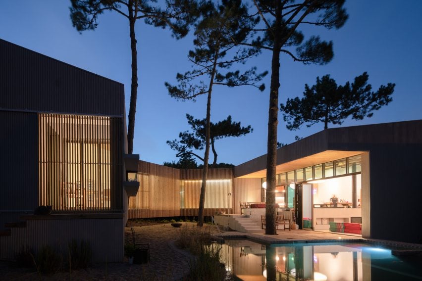 Photograph of a house with warm lighting during the evening by Atelier Data