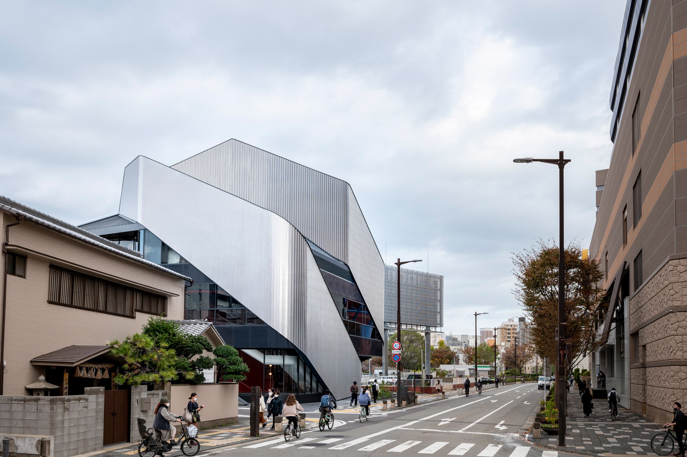 A theatre building on a city street with sweeping steel panels covering the exterior
