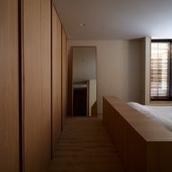 Bedroom with built-in timber wardrobes and full length mirror