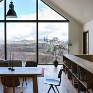 Open-plan dining room with wooden table and chairs and a glazed gable end