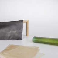 Rolls of fabric made from algae on plain backdrop