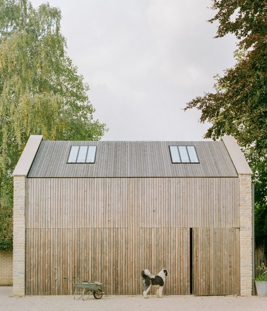 Free-standing stone garage clad in timber