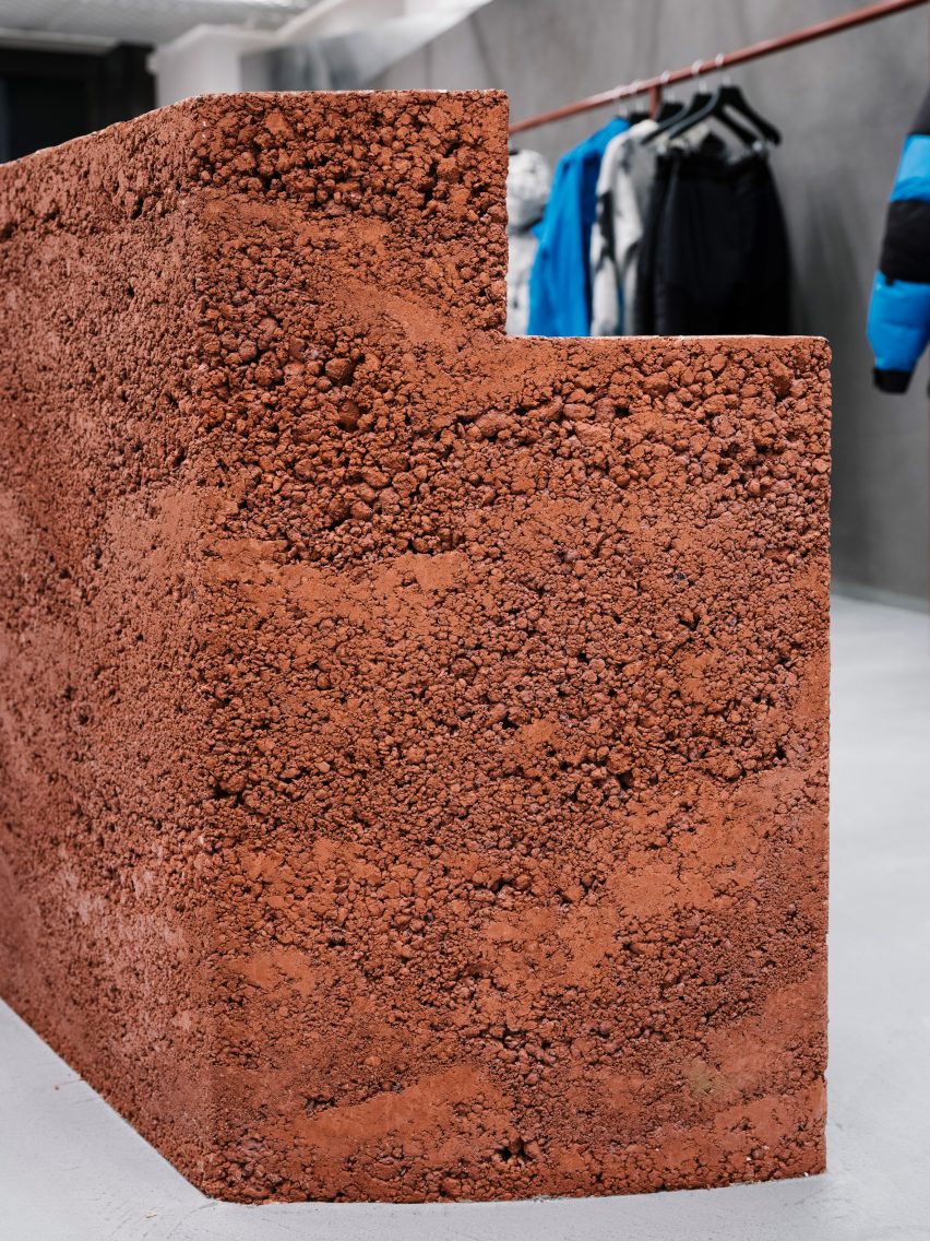 Close up of the rammed-earth display islands at the 66 Degrees North clothing store