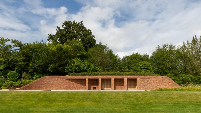 Brick pool house buried under a grass mound in the garden of a Kent home