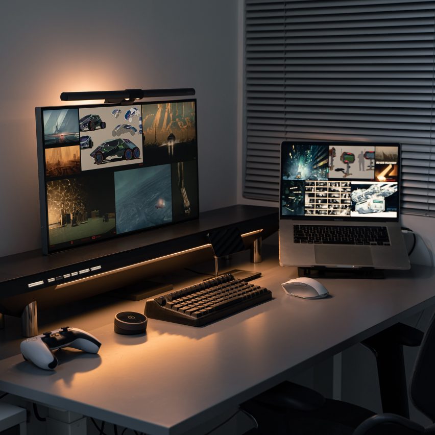 Photo of a desktop with a monitor, laptop and accessories powered by the Hexcal Studio desktop management system, lit by the soft glow of an indirect light