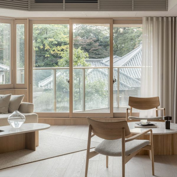 Wooden furniture and artworks decorate Hiroo Residence in Tokyo