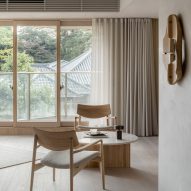 Wooden furniture and artworks decorate Hiroo Residence in Tokyo