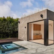 Rectangular stucco pool house by a residential swimming pool