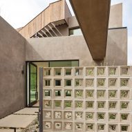 Roof terrace with a perforated partition wall at a home with stucco walls