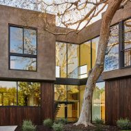 Stucco and ash-clad home with a swimming pool and elm tree in front