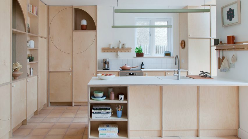 A kitchen with plywood storage