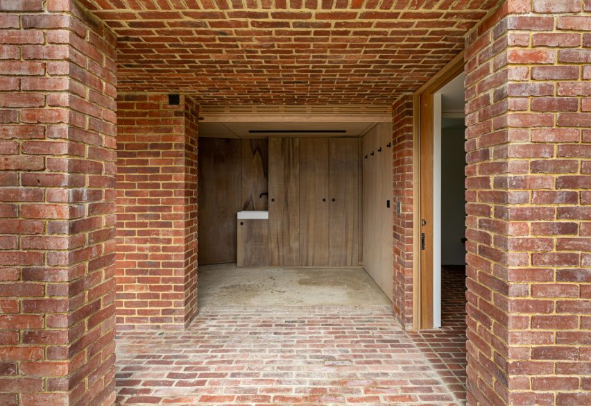 One-storey brick structure with a square opening leading to a changing room with wood cupboards