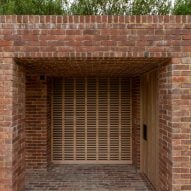 One-storey brick structure with a square opening topped with planting