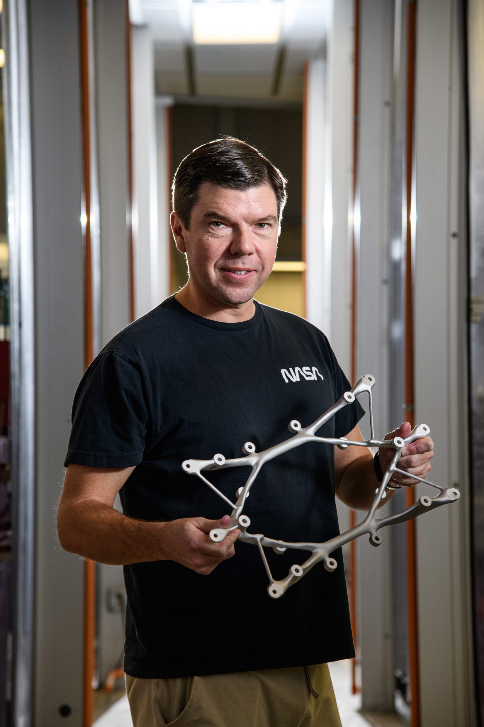 Ryan McClelland displays a structural mount for the Survey and Time-domain Astrophysical Research Explorer (STAR-X) mission.