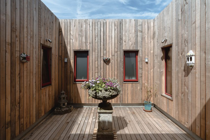 Wood-lined courtyard of home by Studio Bark