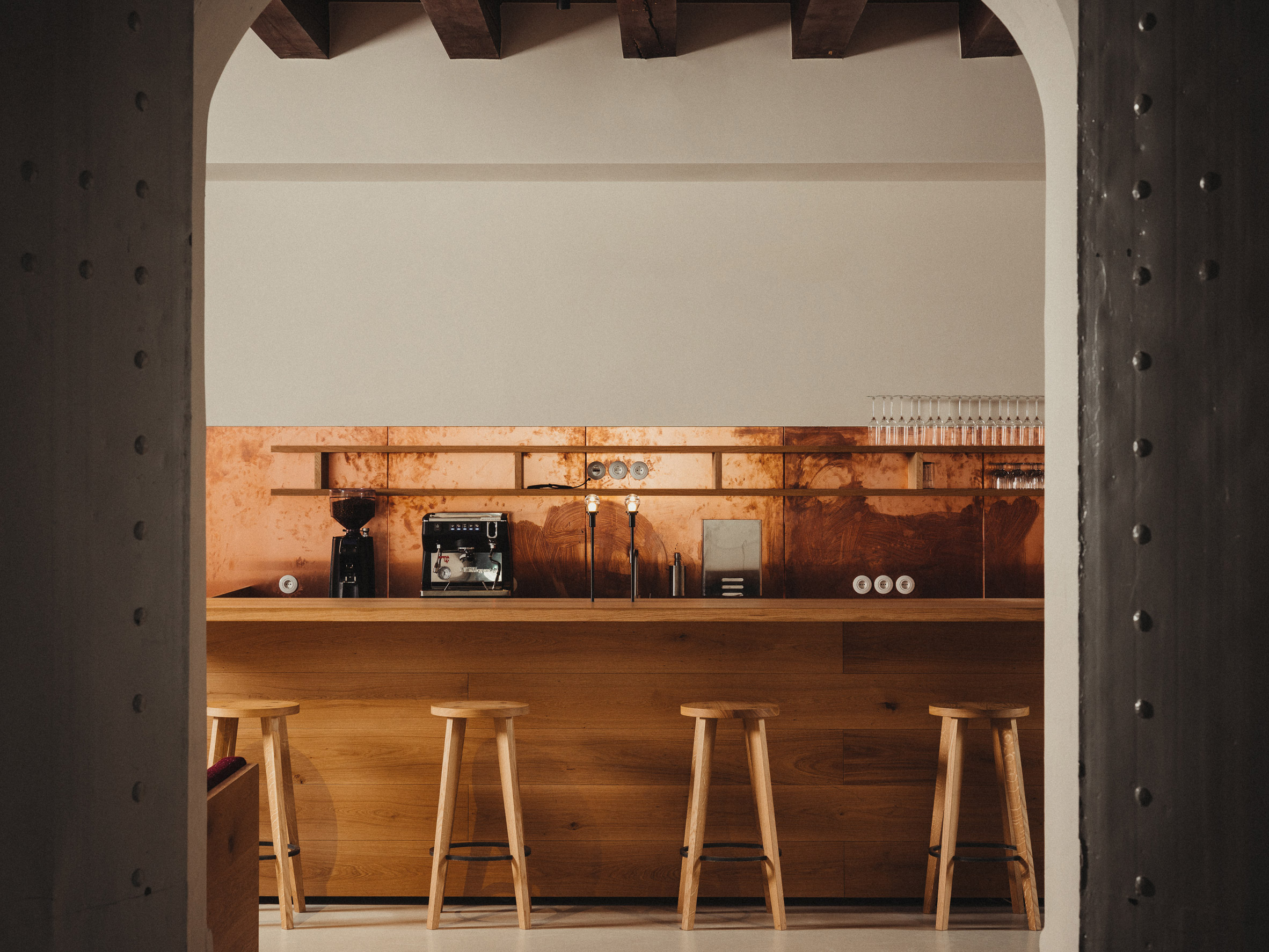 Copper splashback and oak bar in Danish cafe