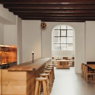 MEE Studio creates wood-and-copper interior for cafe in former church in Copenhagen