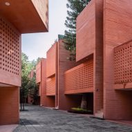 Geometric perforations characterise coloured concrete housing block in Mexico