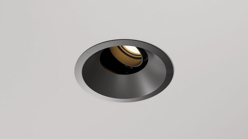Circular downlight recessed in a white ceiling