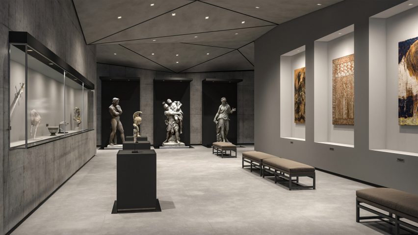 Interior of a grey gallery space with statues and paintings lit by downlights
