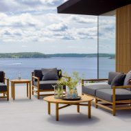 Grey upholstered sofas on a terrace with a sea view